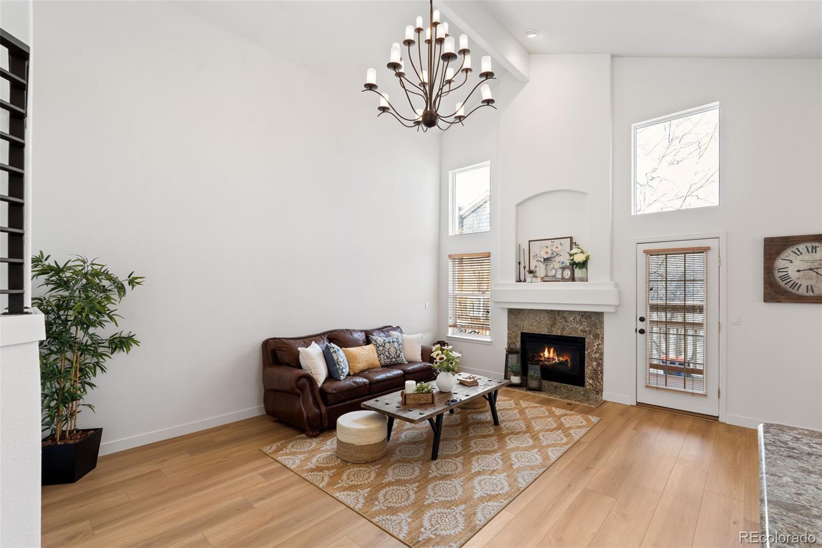9838 Cypress Point Circle Lone Tree, CO 80124 - Photo 12 of 50 a living room with furniture and a fireplace