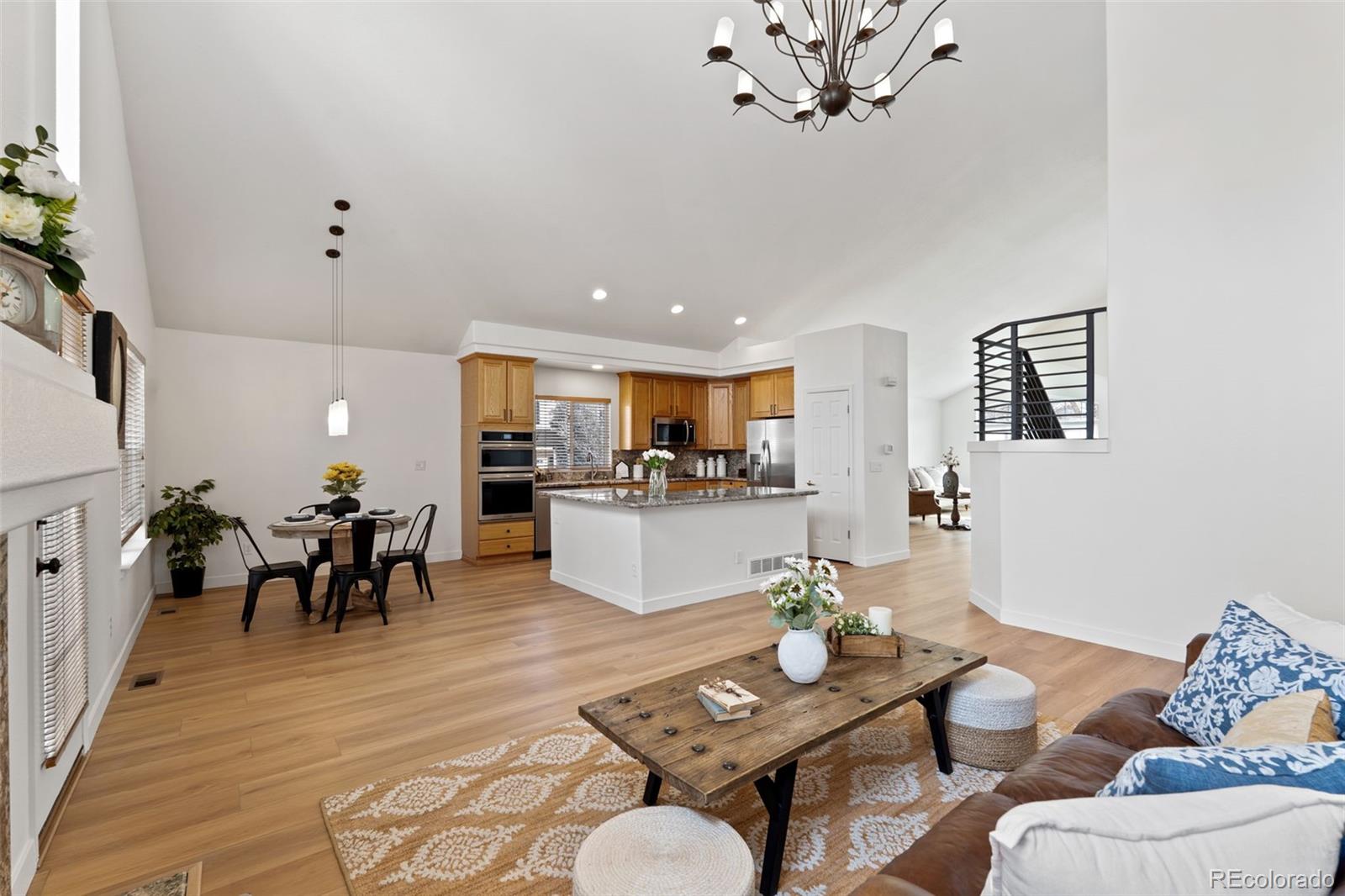 9838 Cypress Point Circle Lone Tree, CO 80124 - Photo 16 of 50 a living room with furniture kitchen view and a dining table