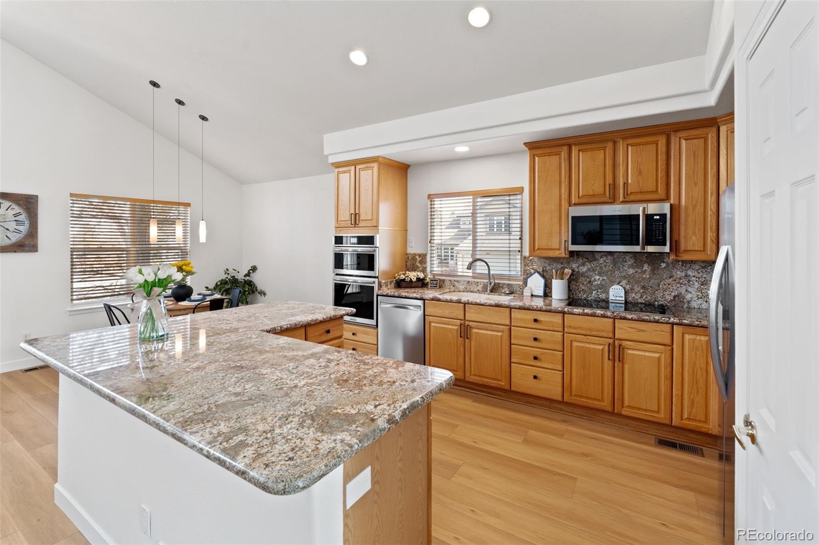 9838 Cypress Point Circle Lone Tree, CO 80124 - Photo 21 of 50 a kitchen with stainless steel appliances granite countertop sink stove and granite counter top