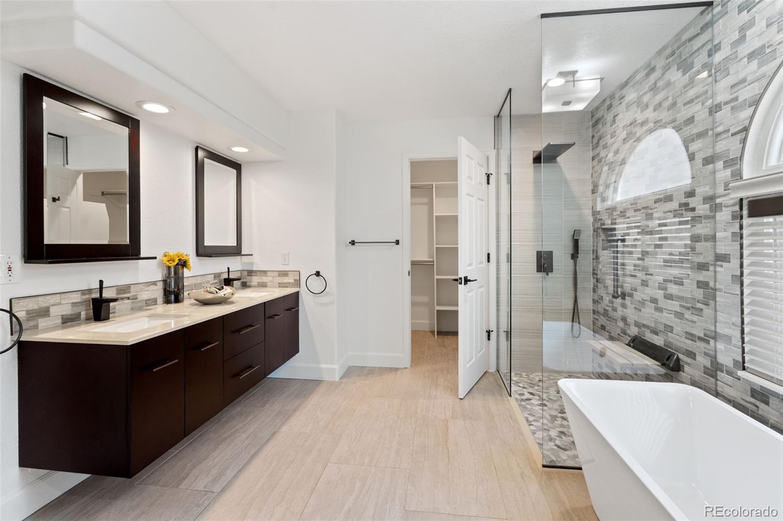 9838 Cypress Point Circle Lone Tree, CO 80124 - Photo 26 of 50 a bathroom with a tub sink shower and mirror