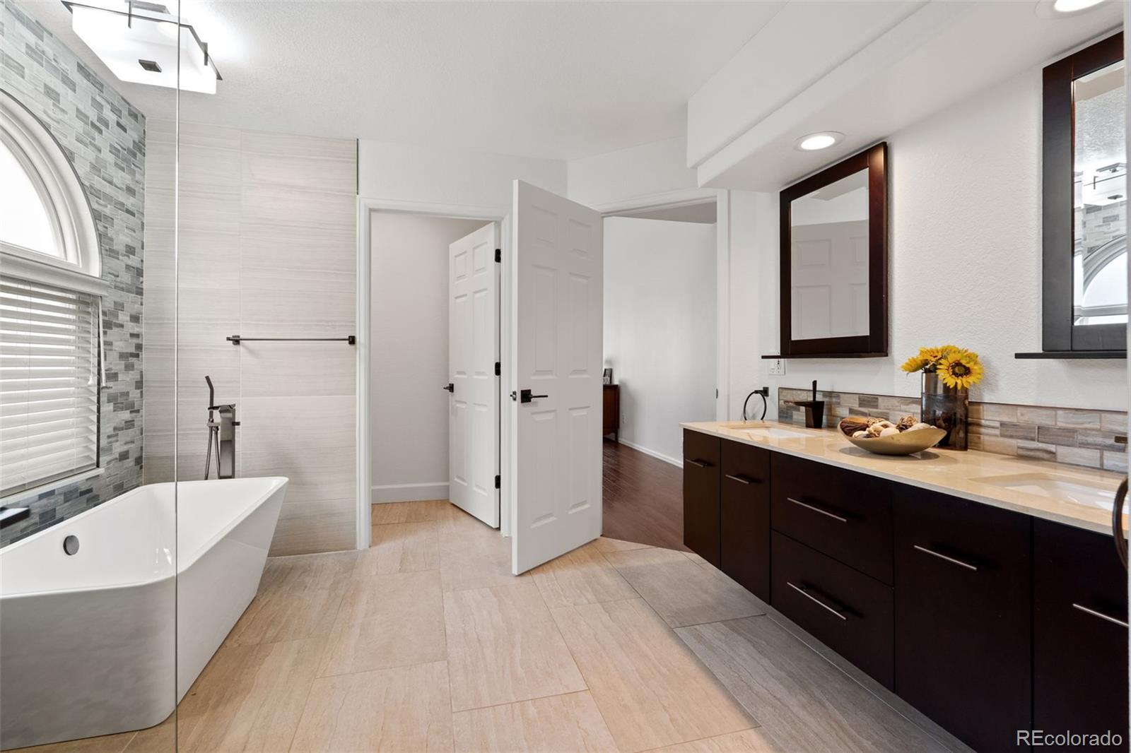 9838 Cypress Point Circle Lone Tree, CO 80124 - Photo 27 of 50 a spacious bathroom with a tub sink shower and mirror