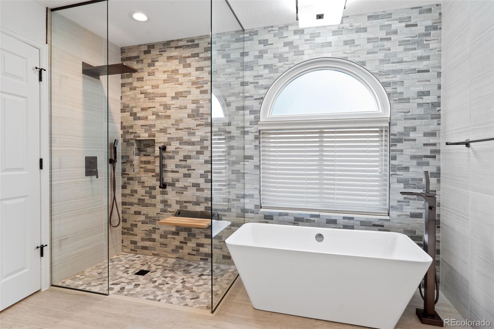 9838 Cypress Point Circle Lone Tree, CO 80124 - Photo 28 of 50 a bathroom with a bathtub and shower