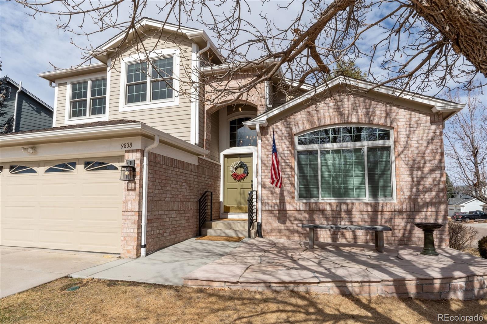 9838 Cypress Point Circle Lone Tree, CO 80124 - Photo 3 of 50 a front view of a house with a yard