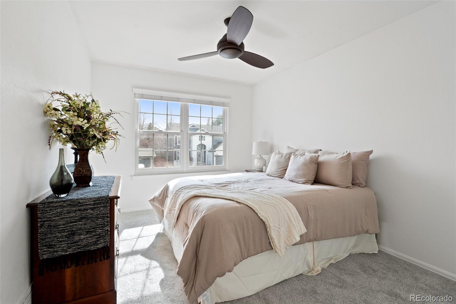 9838 Cypress Point Circle Lone Tree, CO 80124 - Photo 36 of 50 a bed sitting in a bedroom next to a window