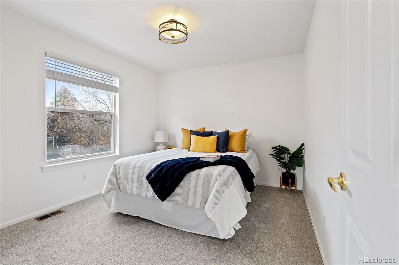 9838 Cypress Point Circle Lone Tree, CO 80124 - Photo 37 of 50 a bedroom with a bed and window