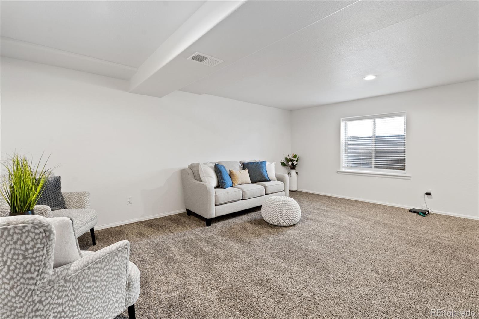 9838 Cypress Point Circle Lone Tree, CO 80124 - Photo 39 of 50 a living room with furniture and a window