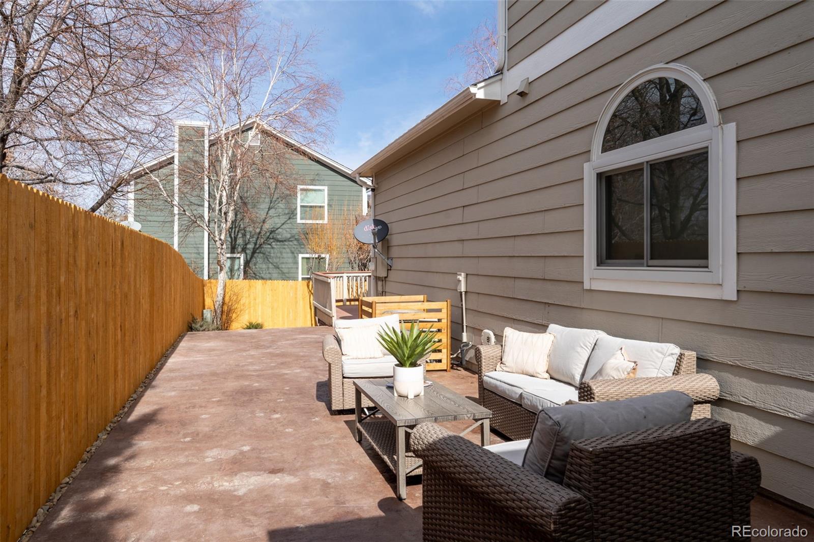 9838 Cypress Point Circle Lone Tree, CO 80124 - Photo 44 of 50 a view of a patio with couches chairs and wooden floor