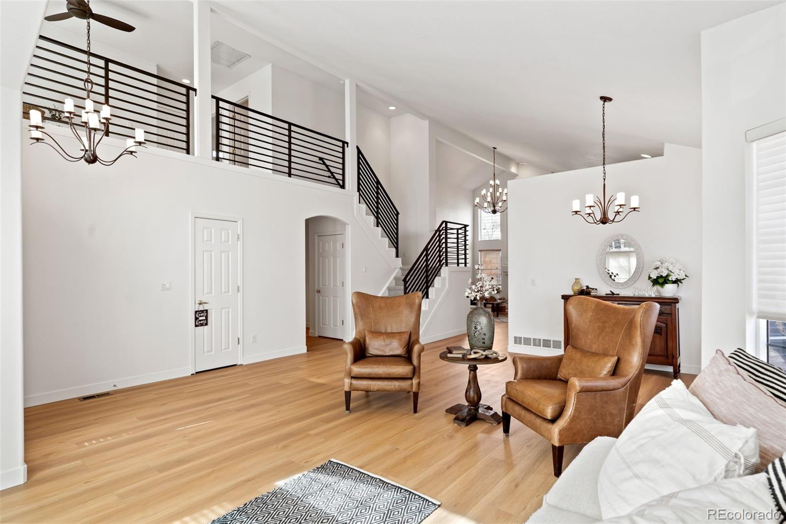 9838 Cypress Point Circle Lone Tree, CO 80124 - Photo 5 of 50 a view of a livingroom with furniture and staircase