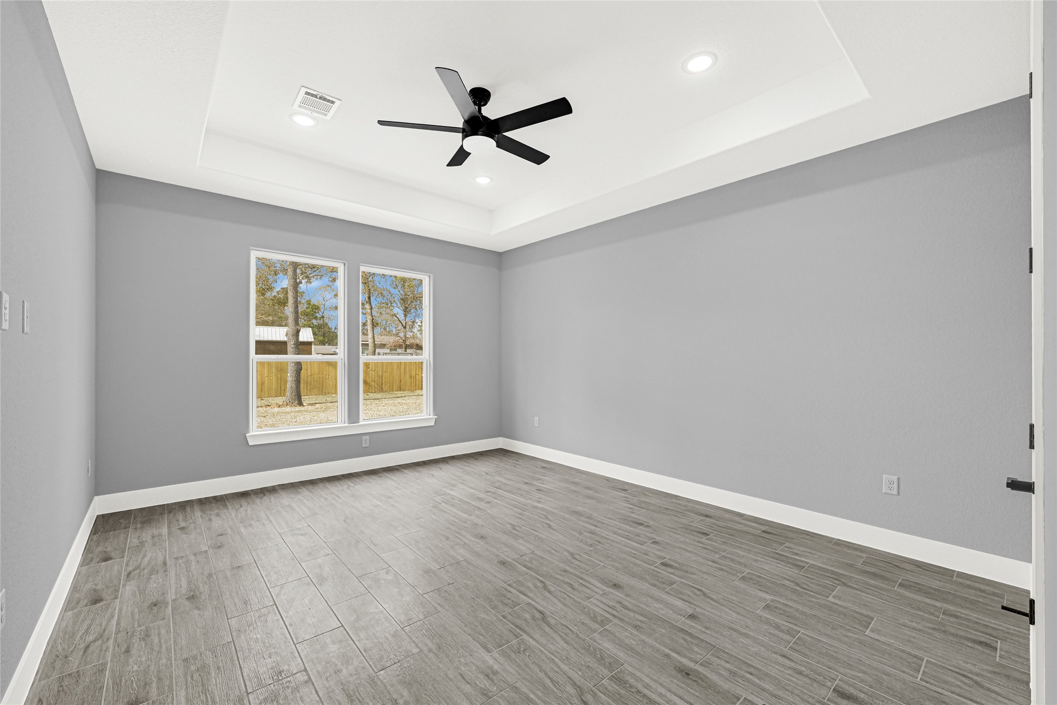 515 Fairfax Lane Conroe, TX 77303 - Photo 16 of 26 wooden floor in an empty room with a window