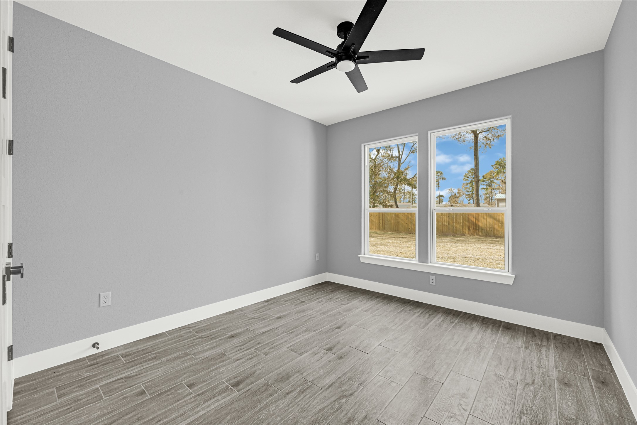 515 Fairfax Lane Conroe, TX 77303 - Photo 19 of 26 wooden floor in an empty room with a window