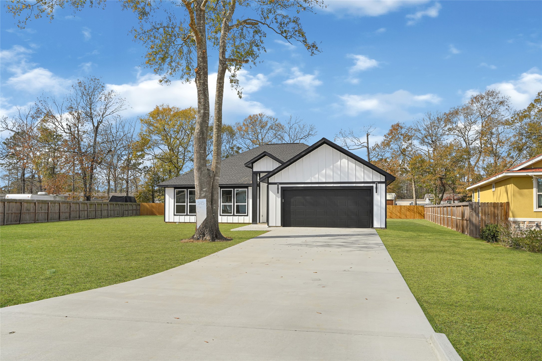 515 Fairfax Lane Conroe, TX 77303 - Photo 2 of 26 a front view of a house with garden