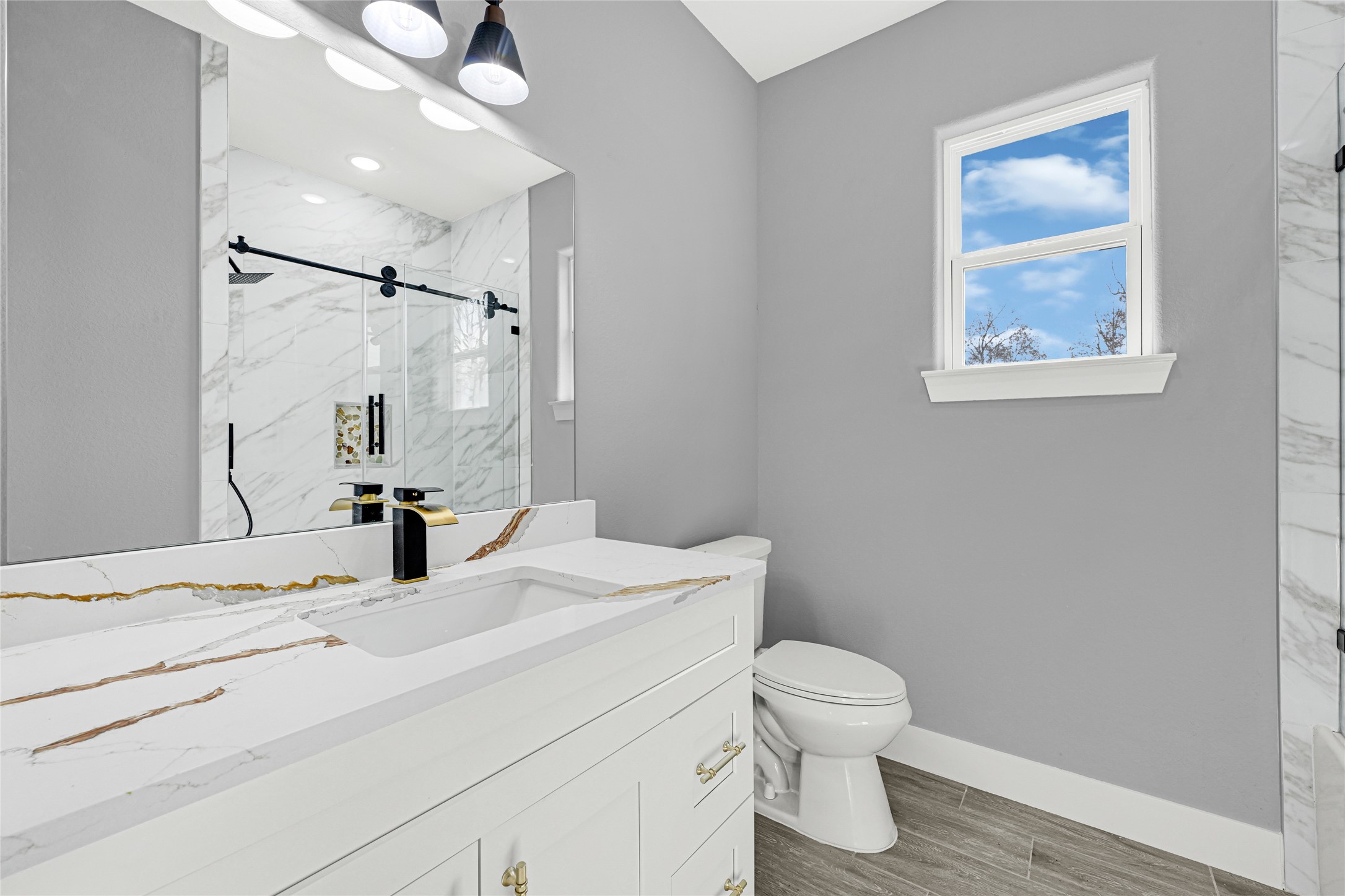 515 Fairfax Lane Conroe, TX 77303 - Photo 21 of 26 a bathroom with a sink toilet and vanity