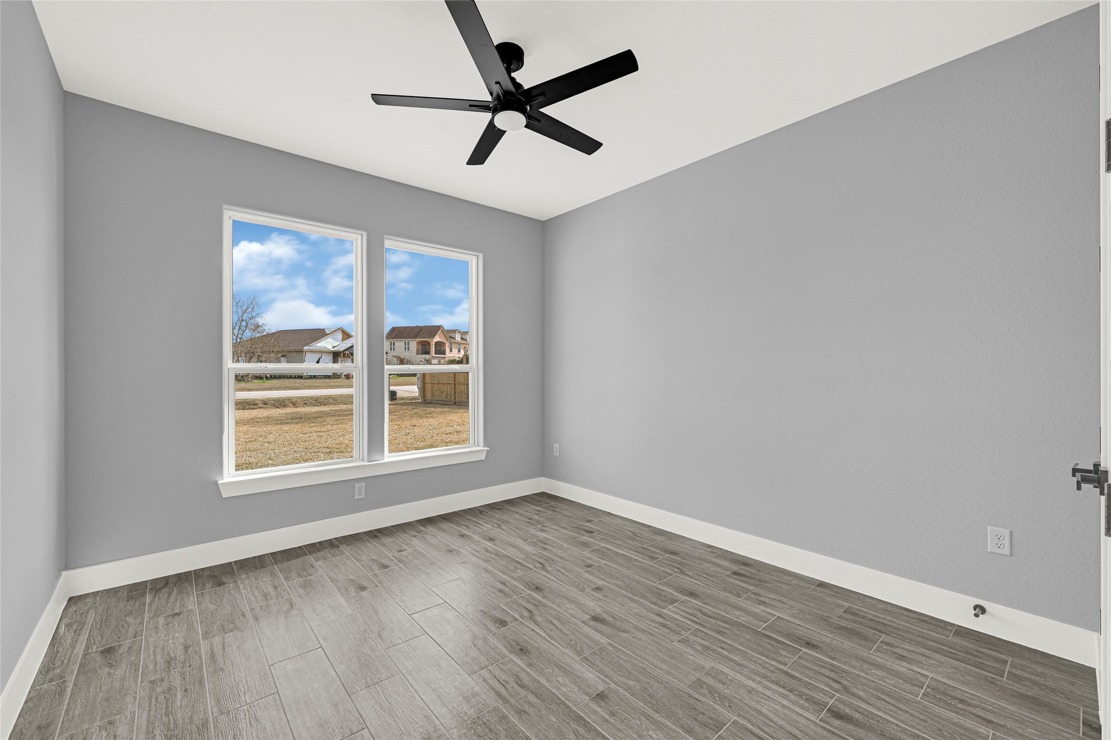 515 Fairfax Lane Conroe, TX 77303 - Photo 22 of 26 wooden floor in an empty room with a window