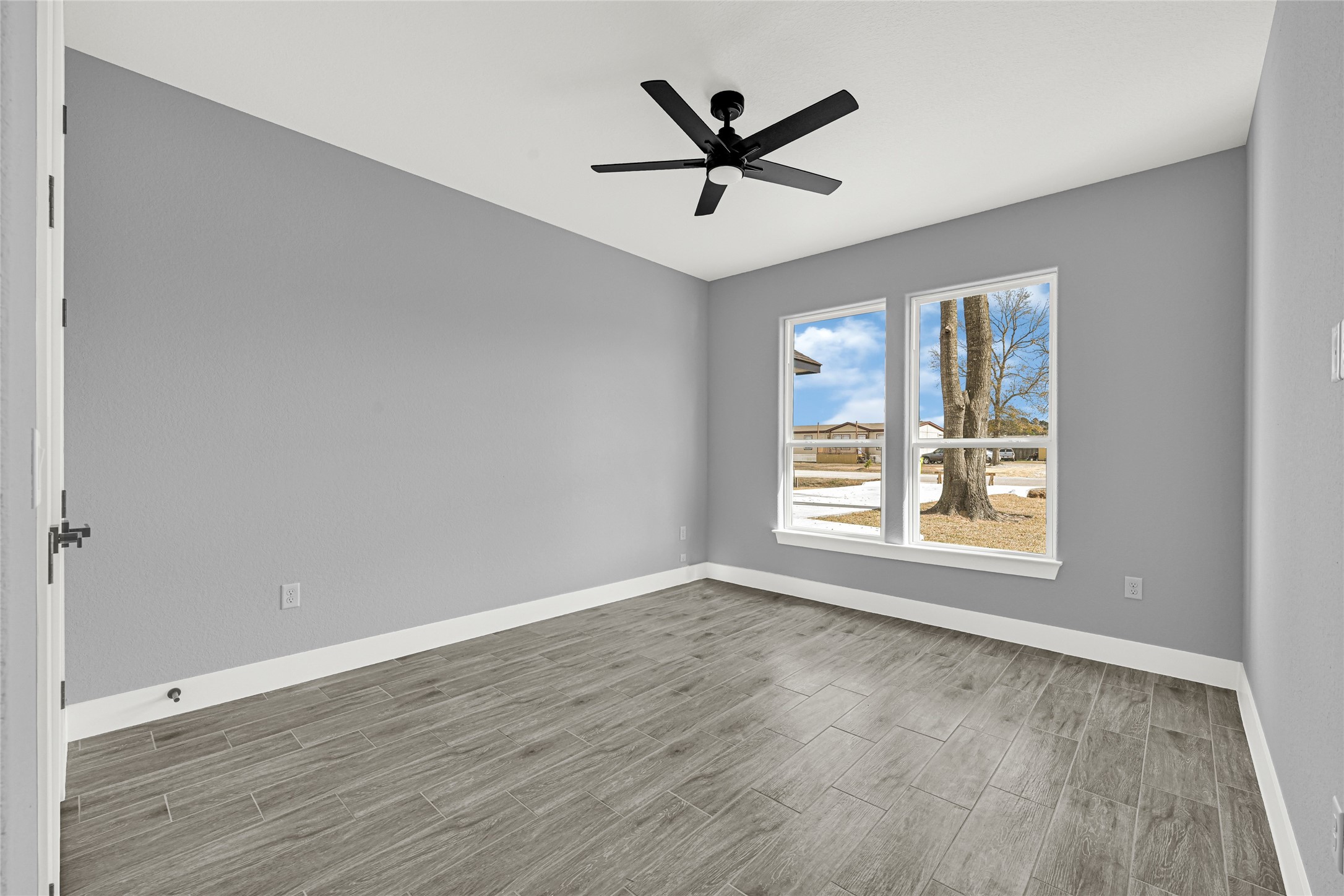 515 Fairfax Lane Conroe, TX 77303 - Photo 23 of 26 a view of a big room with wooden floor and windows