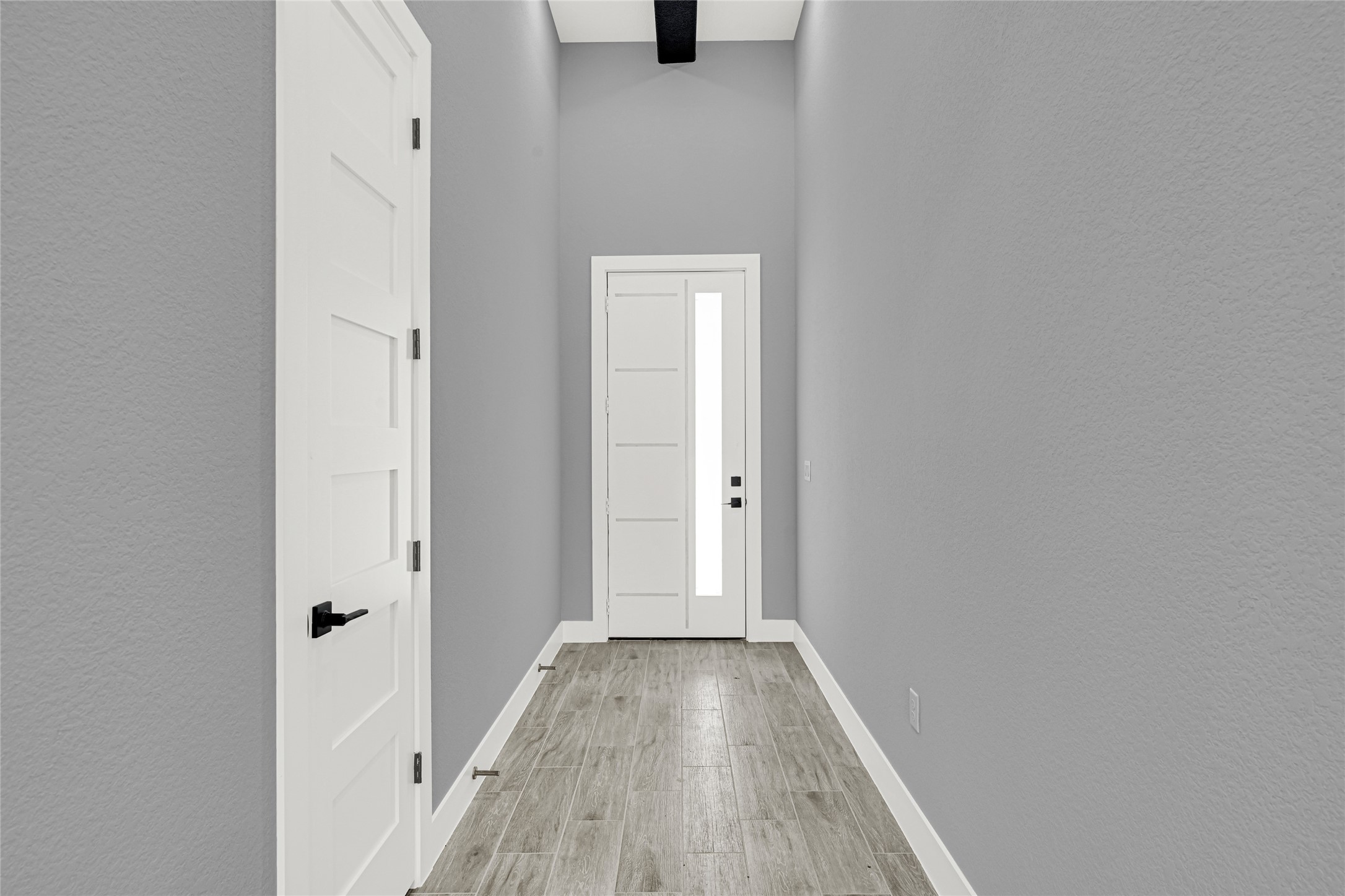 515 Fairfax Lane Conroe, TX 77303 - Photo 5 of 26 a view of a hallway with wooden floor
