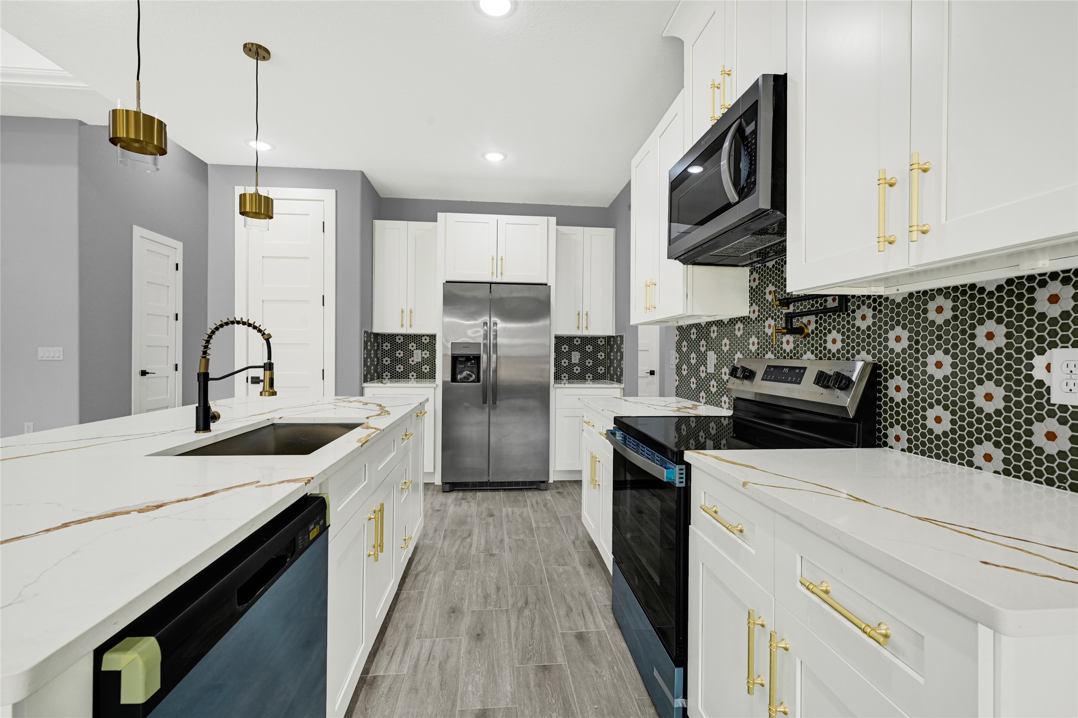 515 Fairfax Lane Conroe, TX 77303 - Photo 6 of 26 a kitchen with a sink and a stove top oven with wooden floor