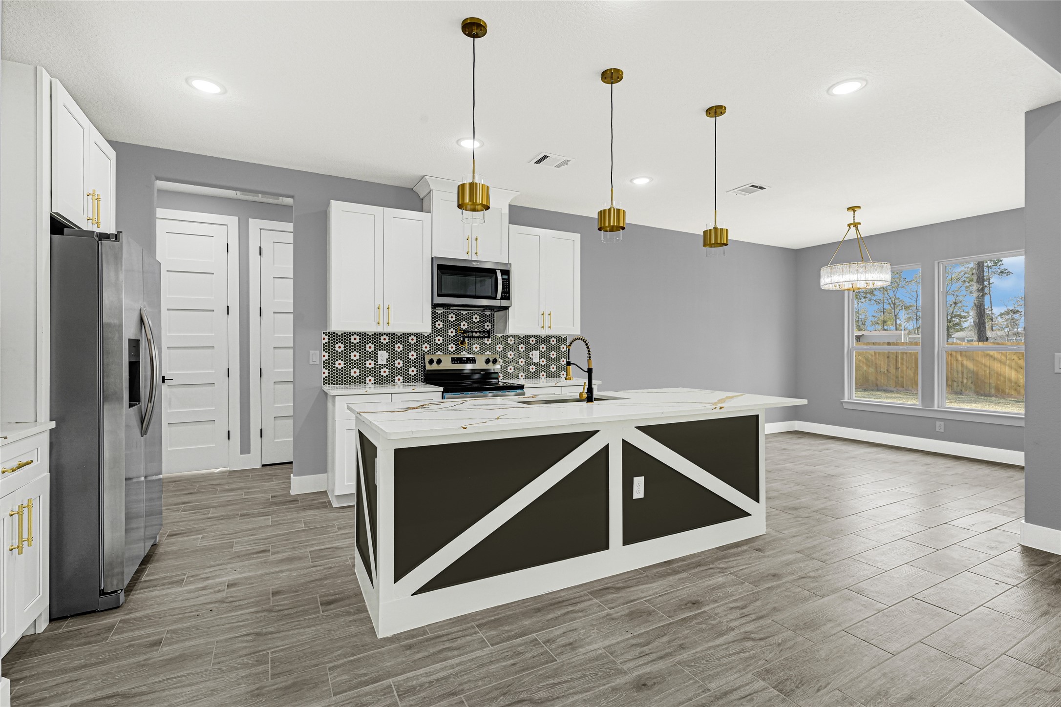 515 Fairfax Lane Conroe, TX 77303 - Photo 8 of 26 a kitchen with stainless steel appliances granite countertop a stove a sink and a refrigerator