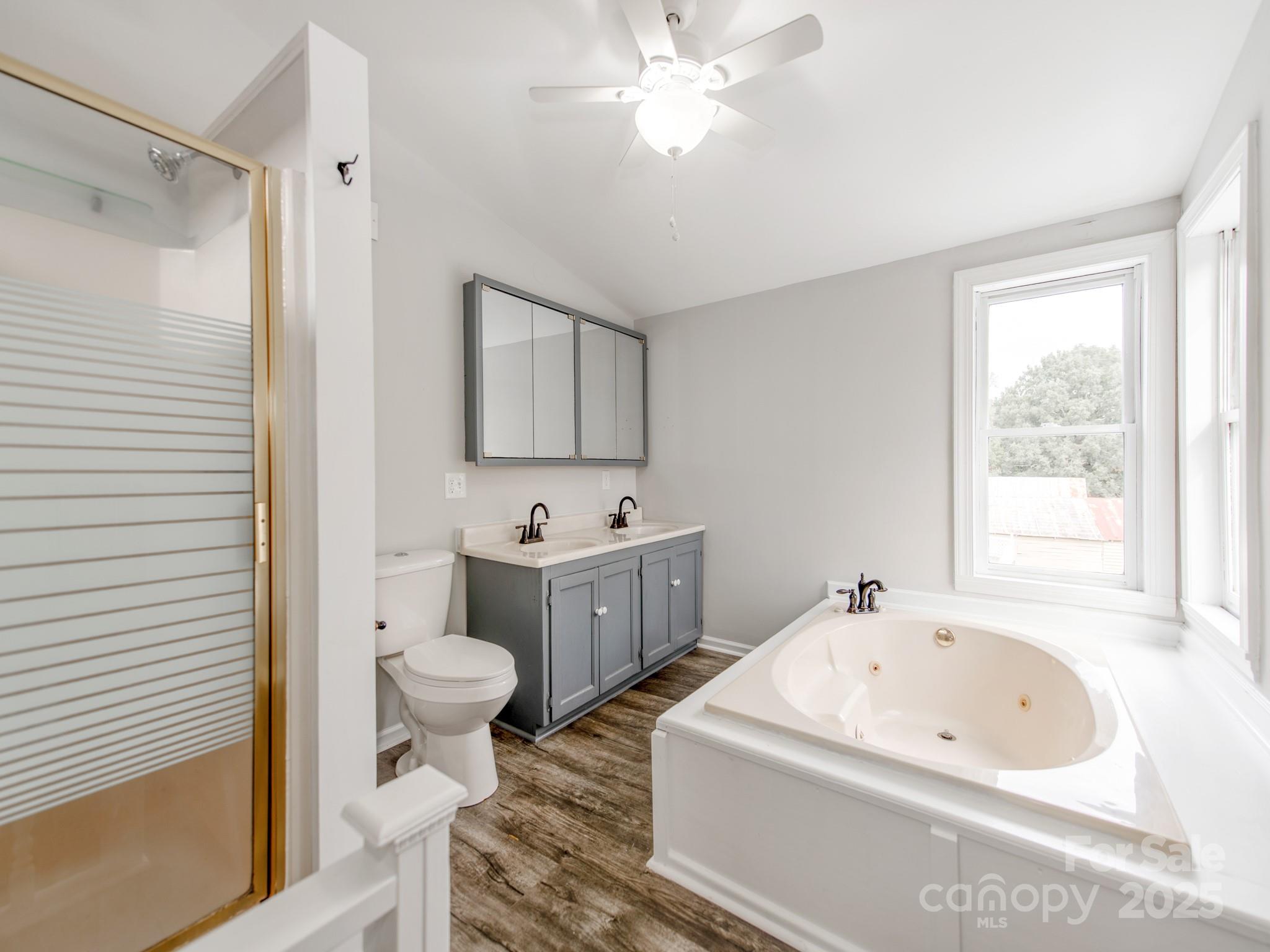 3607 Austin Road Monroe, NC 28112 - Photo 22 of 39 a bathroom with a tub sink toilet and mirror