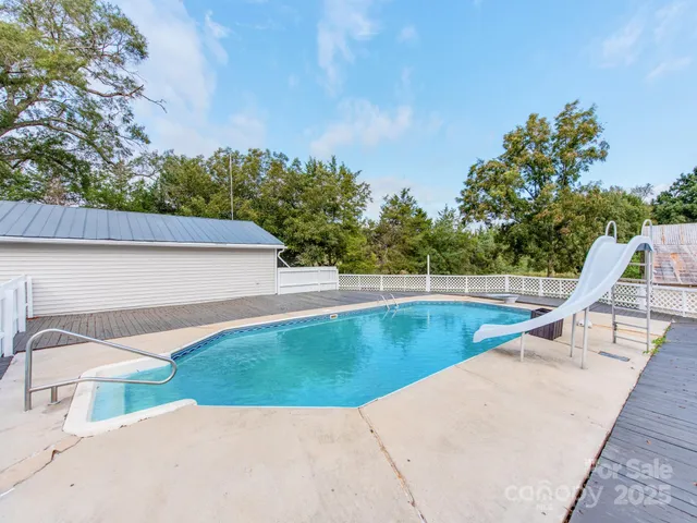 a view of backyard with swimming pool
