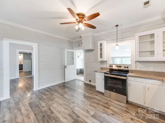 a kitchen with stainless steel appliances a stove a sink and a refrigerator
