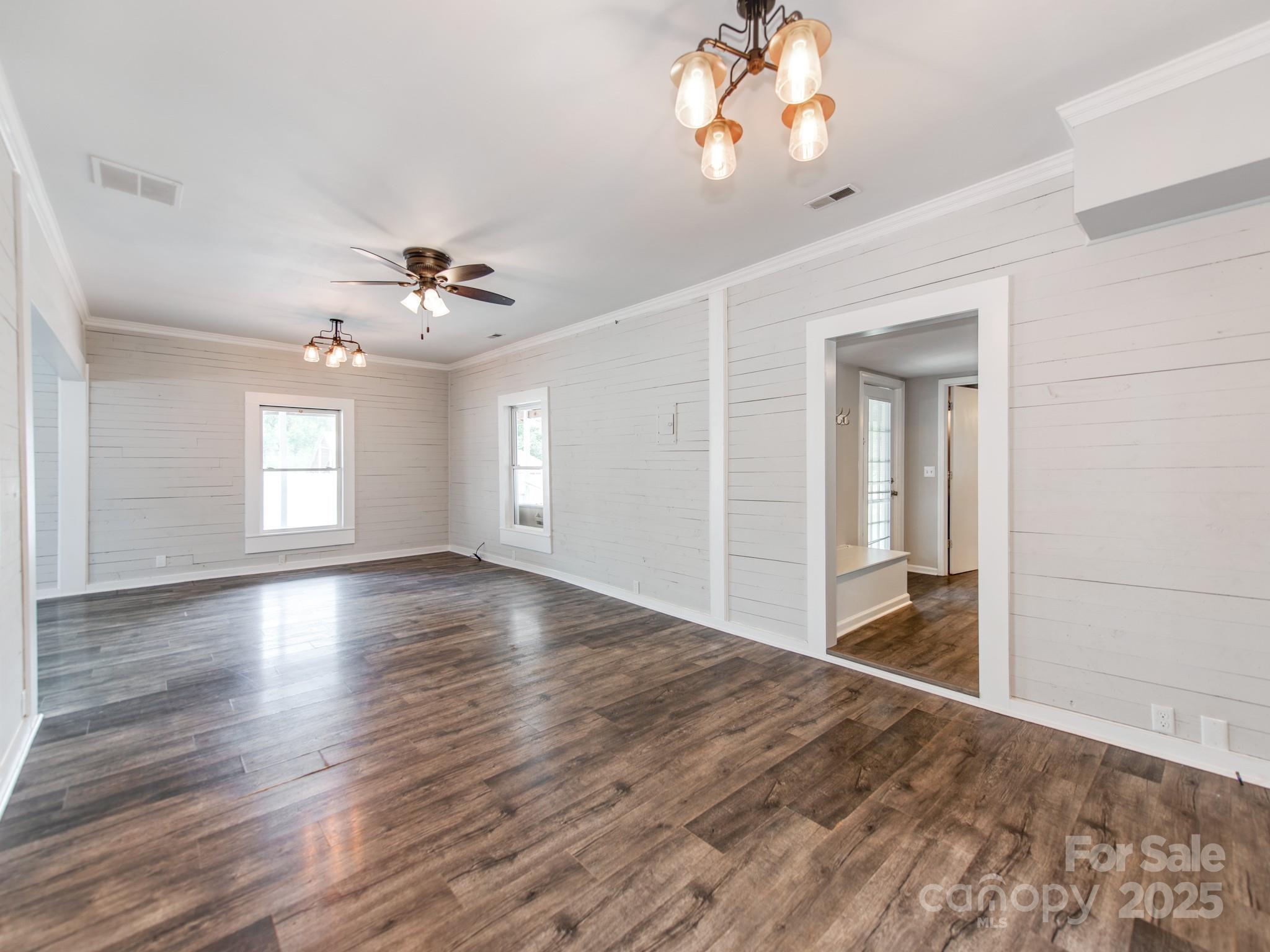3607 Austin Road Monroe, NC 28112 - Photo 9 of 39 a view of an empty room with a window and wooden floor