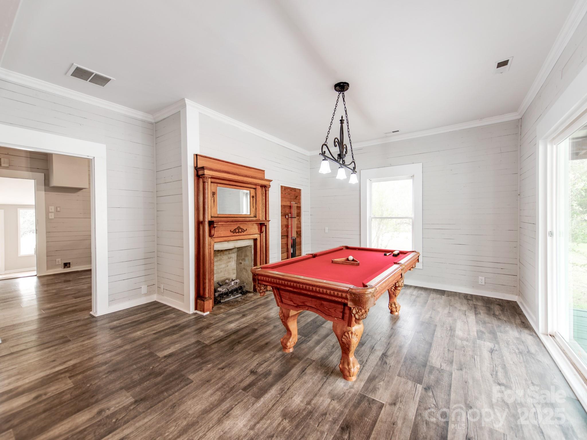 3607 Austin Road Monroe, NC 28112 - Photo 10 of 39 a room with pool table wooden floor and chandelier
