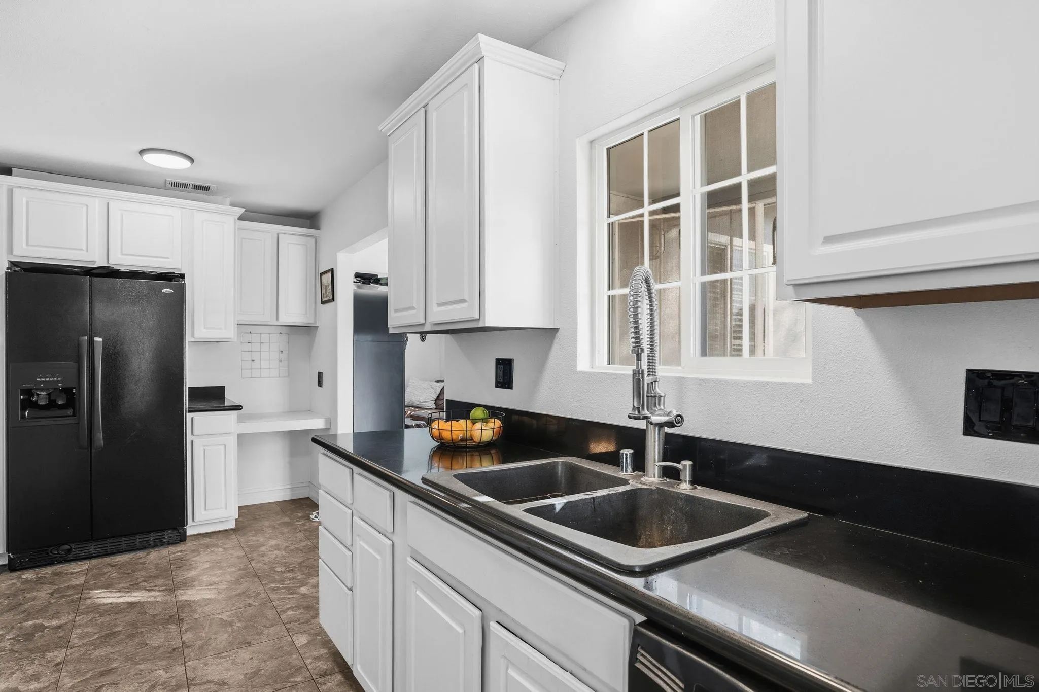 480 Orlando Street El Cajon, CA 92021 - Photo 12 of 25 a kitchen that has a sink and cabinets