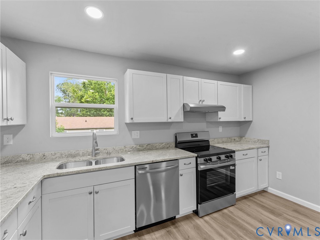 6204 Walderbrook Road Richmond, VA 23234 - Photo 9 of 32 Modern kitchen featuring white cabinetry, granite-