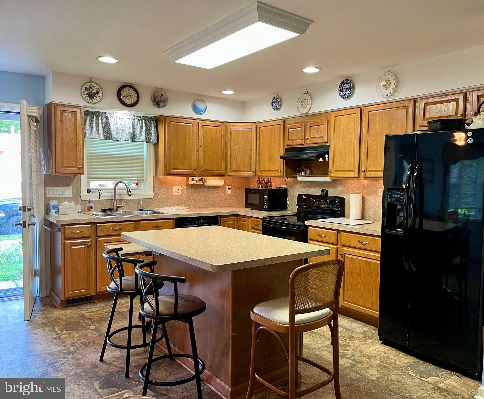 870 Broadfield Drive Newark, DE 19713 - Photo 2 of 13 a kitchen with stainless steel appliances granite countertop a stove a refrigerator a sink a dining table and chairs