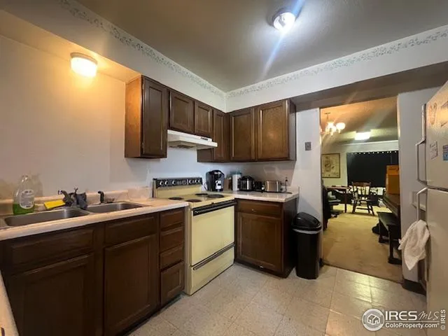 a kitchen with a sink a stove and cabinets