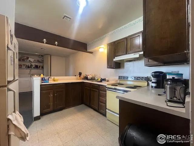 a kitchen with stainless steel appliances granite countertop a stove a sink dishwasher and a microwave oven with cabinets