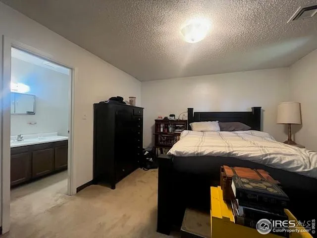 a bedroom with a bed and mirror