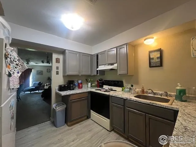 a kitchen with a sink stove and cabinets