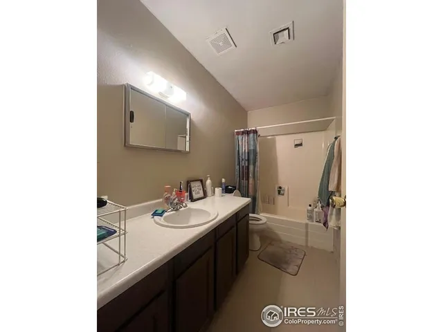 a bathroom with a sink a mirror and a toilet