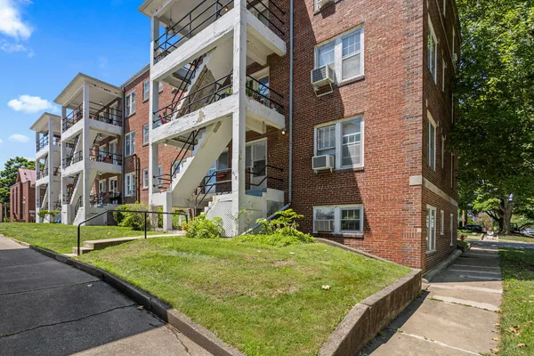 a view of an apartment with a yard