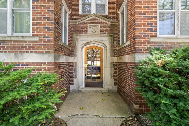 a view of a brick house with many windows