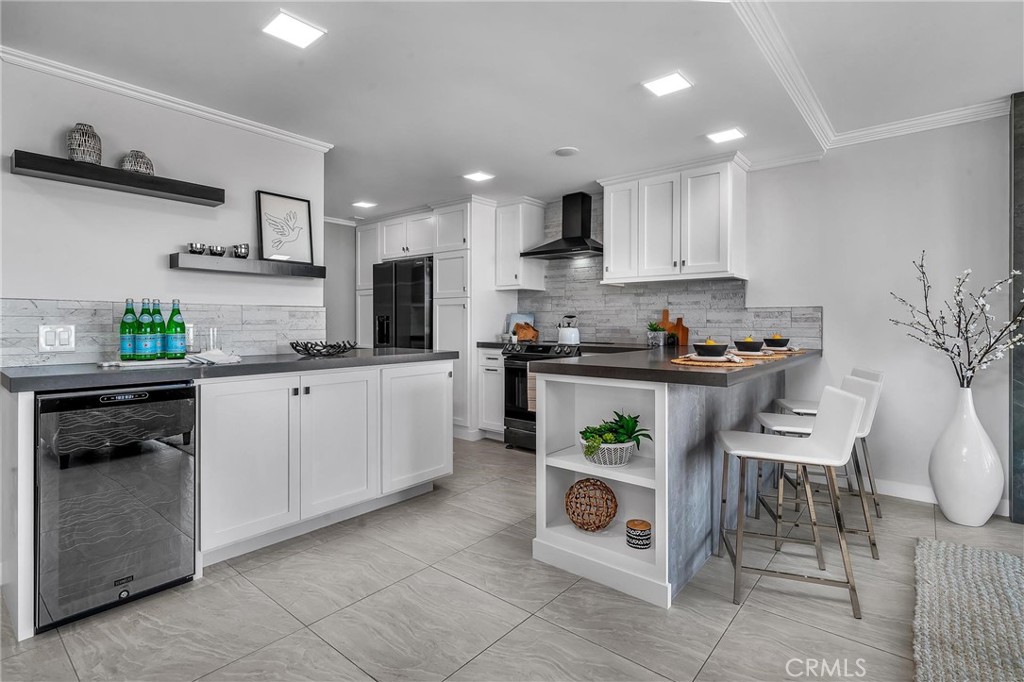531 Esplanade, Unit 505 Redondo Beach, CA 90277 - Photo 13 of 65 a kitchen with stainless steel appliances kitchen island granite countertop a sink and cabinets