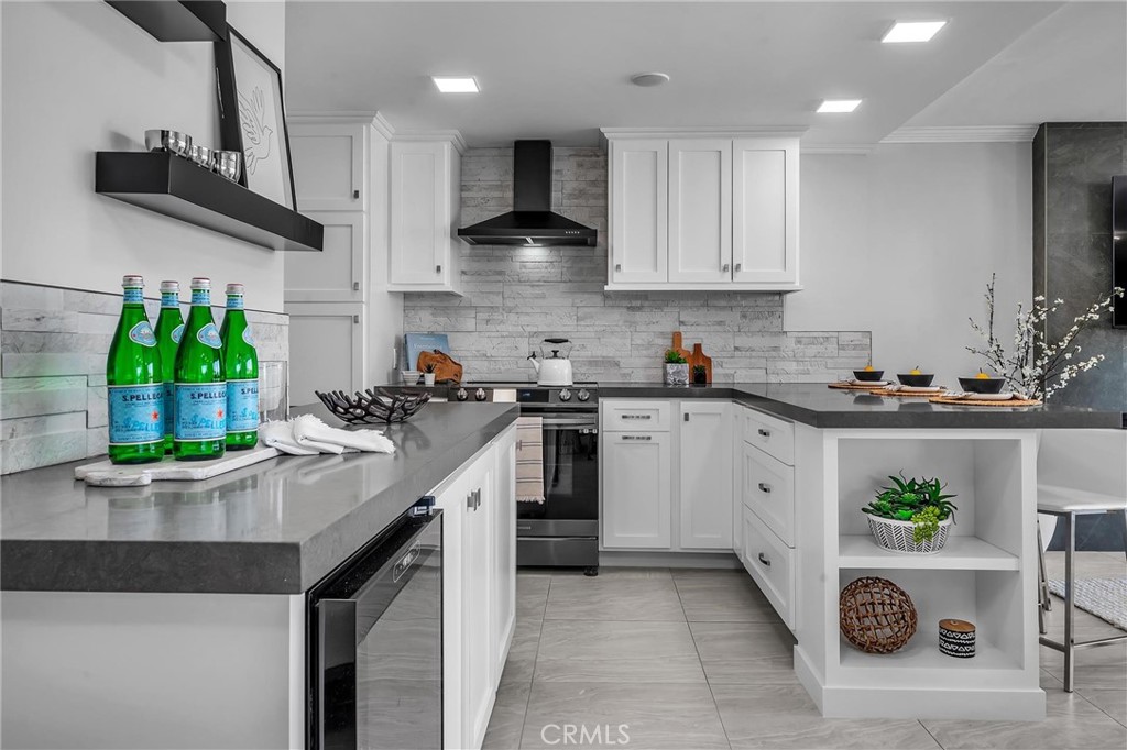 531 Esplanade, Unit 505 Redondo Beach, CA 90277 - Photo 14 of 65 a kitchen with kitchen island granite countertop stainless steel appliances a sink a counter top space cabinets and a potted plant