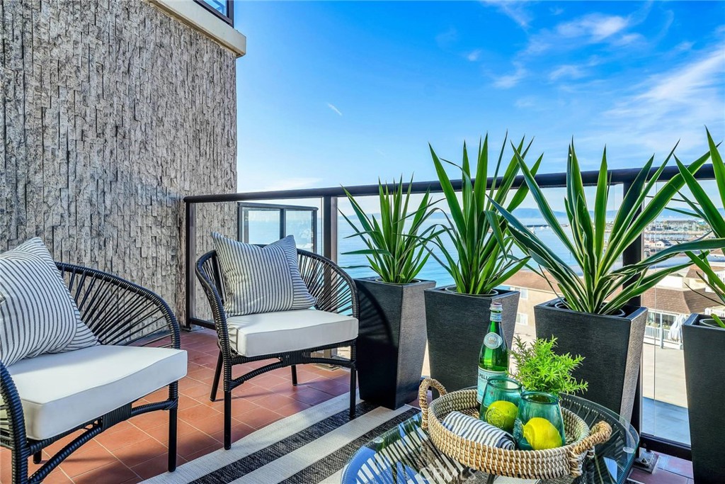531 Esplanade, Unit 505 Redondo Beach, CA 90277 - Photo 21 of 65 a porch with a potted plant and a chair
