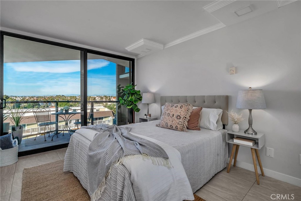 531 Esplanade, Unit 505 Redondo Beach, CA 90277 - Photo 29 of 65 a bedroom with a large bed and a balcony view