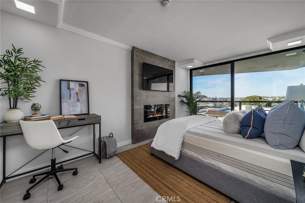 531 Esplanade, Unit 505 Redondo Beach, CA 90277 - Photo 36 of 65 a bedroom with a large bed and a potted plant