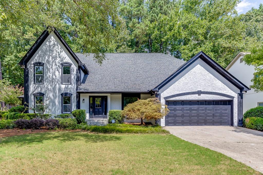 a front view of a house with garden