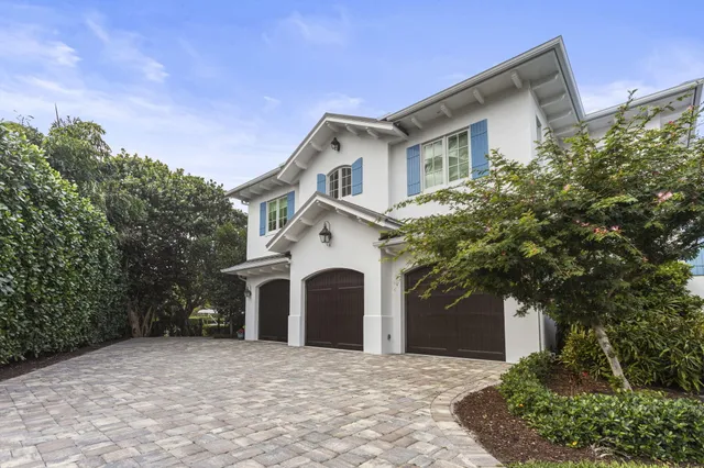 a kitchen with stainless steel appliances kitchen island granite countertop a table chairs and white cabinets