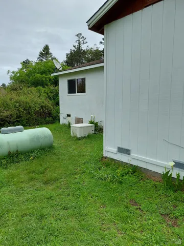 a view of a house with backyard sitting area and garden