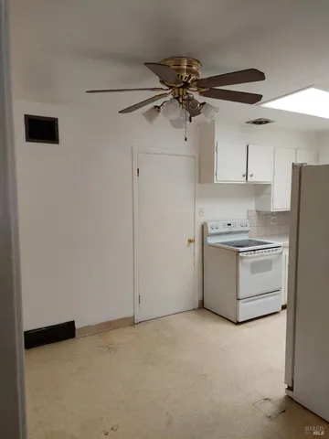 a utility room with cabinets washer and dryer