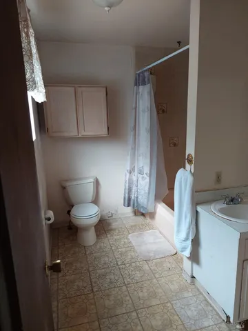 a bathroom with a toilet and a sink
