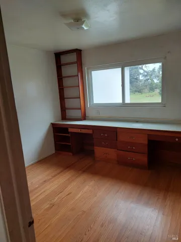 a view of room with window and wooden floor