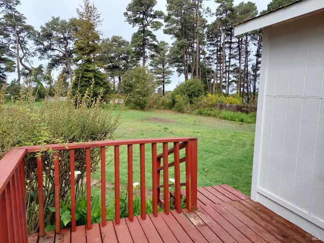 a view of outdoor space with deck and yard