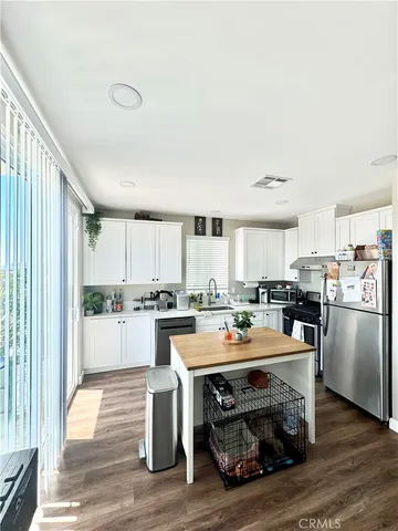 a kitchen with a stove a sink and a refrigerator