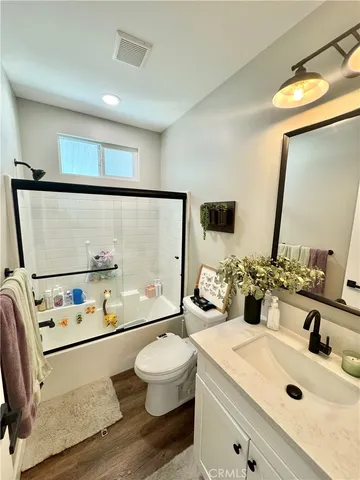 a bathroom with a sink mirror vanity and toilet